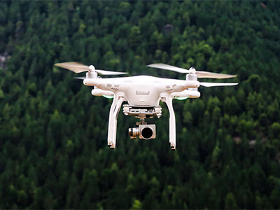 A drone flying above trees
