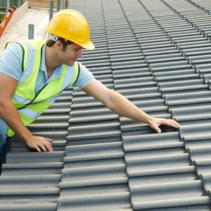 professional inspecting layered tile roof